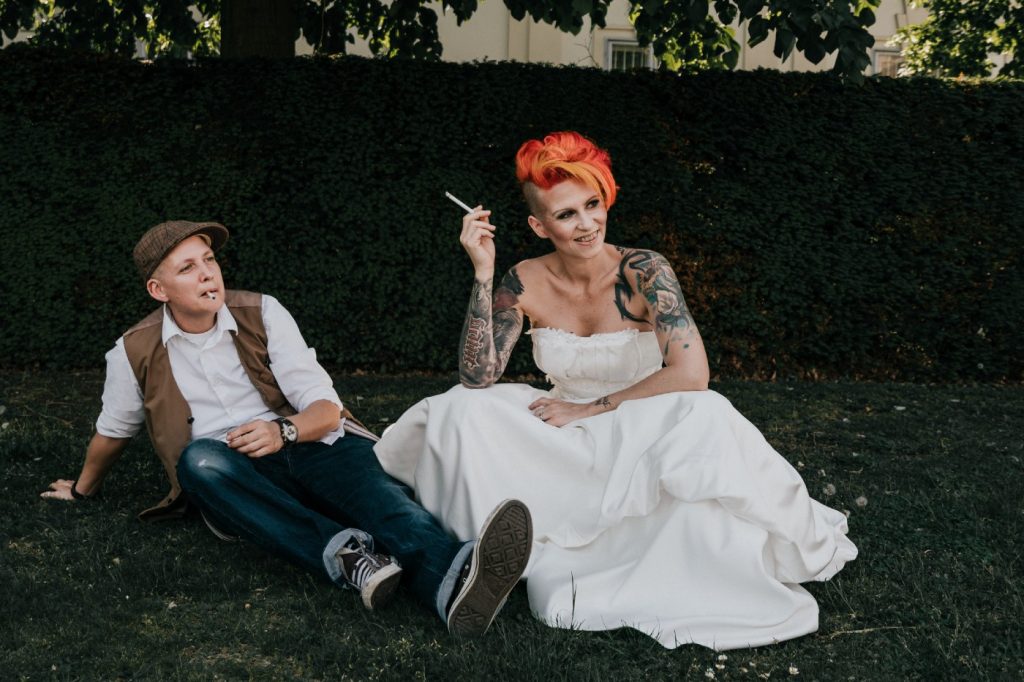 Lesbian couple take time for financial self care while same sex wedding photoshoot by Black Avenue Productions in Europe